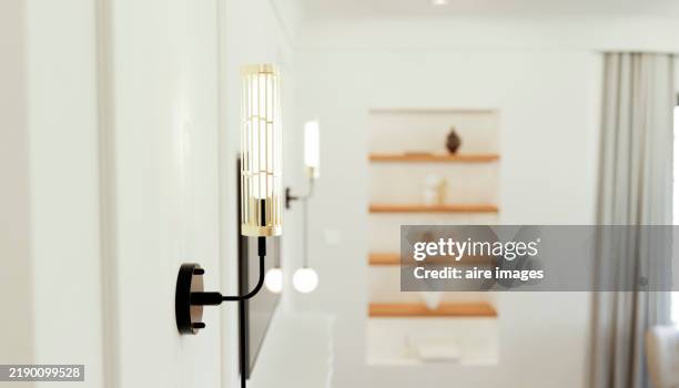 modern wall lamp illuminating a stylish living room - light fitting stock pictures, royalty-free photos & images