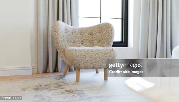 modern beige armchair in a bright living room with window - vida sencilla fotografías e imágenes de stock