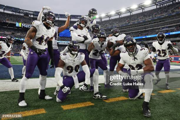The Baltimore Ravens celebrate after Ar'Darius Washington intercepted a pass during the fourth quarter of a game against the New York Giants at...