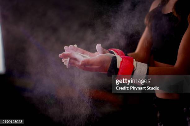 focus on the hand of a child gymnast using magnesium carbon - gymnast stock pictures, royalty-free photos & images