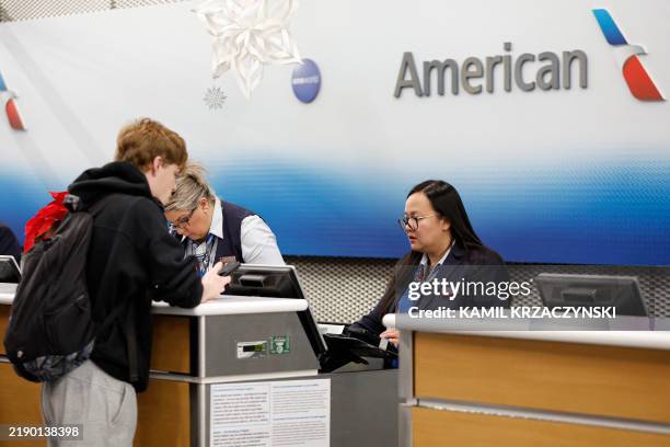 American Airlines agent assists a traveler at O'Hare International Airport in Chicago, Illinois, on December 20, 2024 ahead of the upcoming Christmas...