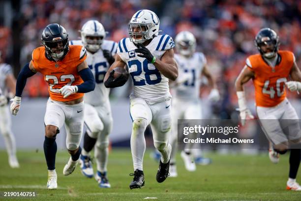 Jonathan Taylor of the Indianapolis Colts runs with the ball for a touchdown during an NFL Football game against the Denver Broncos at Empower Field...