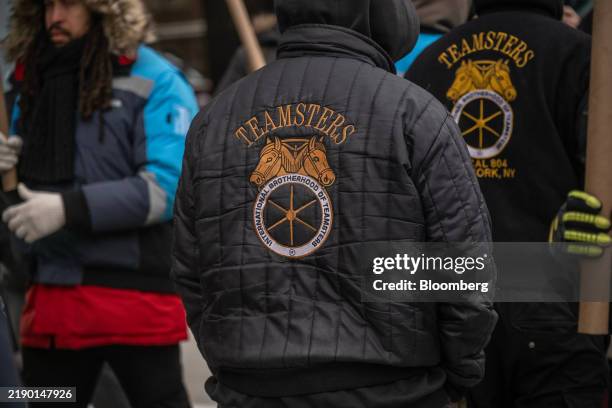 Teamsters jacket is worn as Amazon workers and union members picket outside the DB4 Amazon distribution center in the Queens borough of New York, US,...