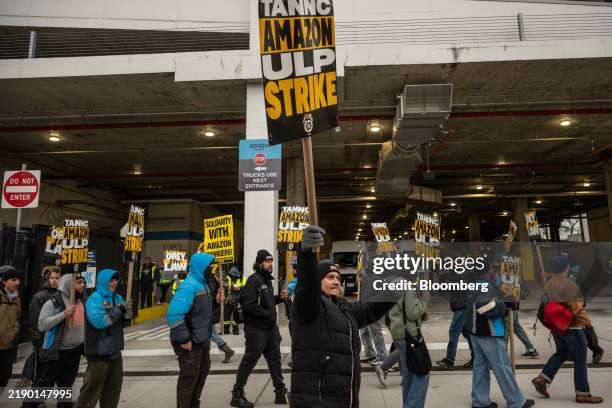 Amazon workers and union members picket outside the DB4 Amazon distribution center in the Queens borough of New York, US, on Friday, Dec. 20, 2024....