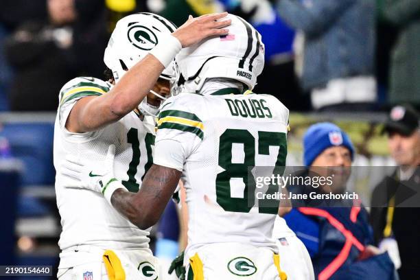 Romeo Doubs of the Green Bay Packers celebrates with teammate Jordan Love after scoring a touchdown against the Seattle Seahawks during the fourth...
