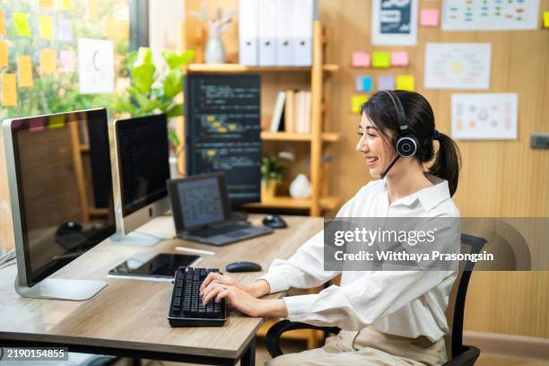 focused female programmer using computer in modern office environment - software programmer stock pictures, royalty-free photos & images