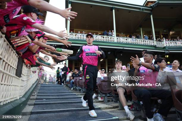 Moises Henriques of the Sixers walks out to field during the BBL match between Sydney Sixers and Melbourne Renegades at Sydney Cricket Ground, on...