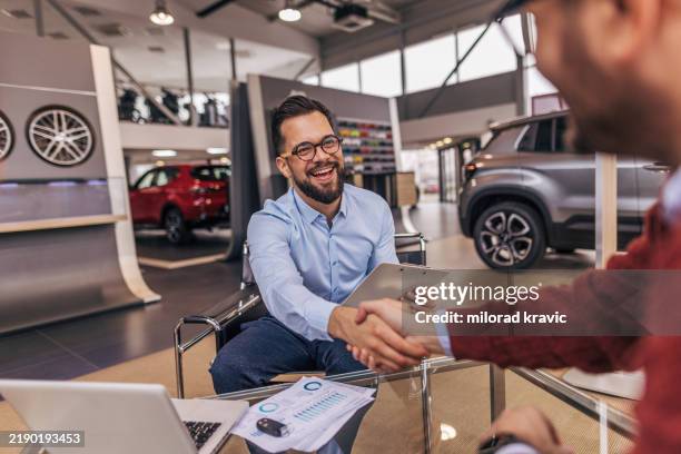 successful cooperation between the buyer and seller - car salesperson stock pictures, royalty-free photos & images
