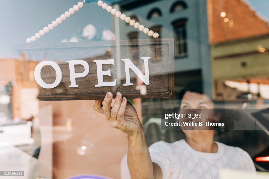 Window Onar Shop Owner Turning Round Her Open Sign In The Window High-Res Stock ...