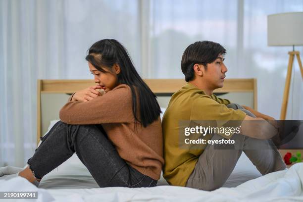 young couple is fighting in bedroom. - healing betrayal stock pictures, royalty-free photos & images