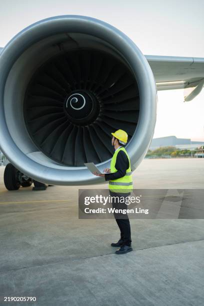 aircraft maintenance worker using laptop computer - hangar stock pictures, royalty-free photos & images