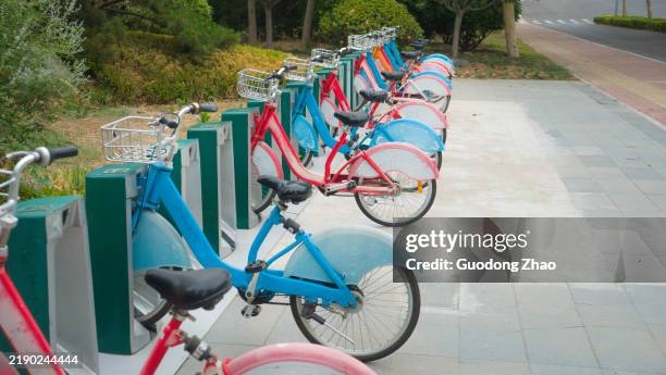 shared bicycles on urban streets - bicycle parking sign stock pictures, royalty-free photos & images