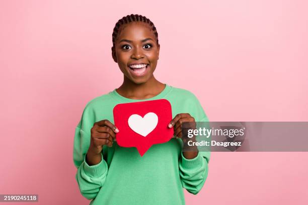 Photo of positive pretty girl hold paper like card look camera isolated on pink color background