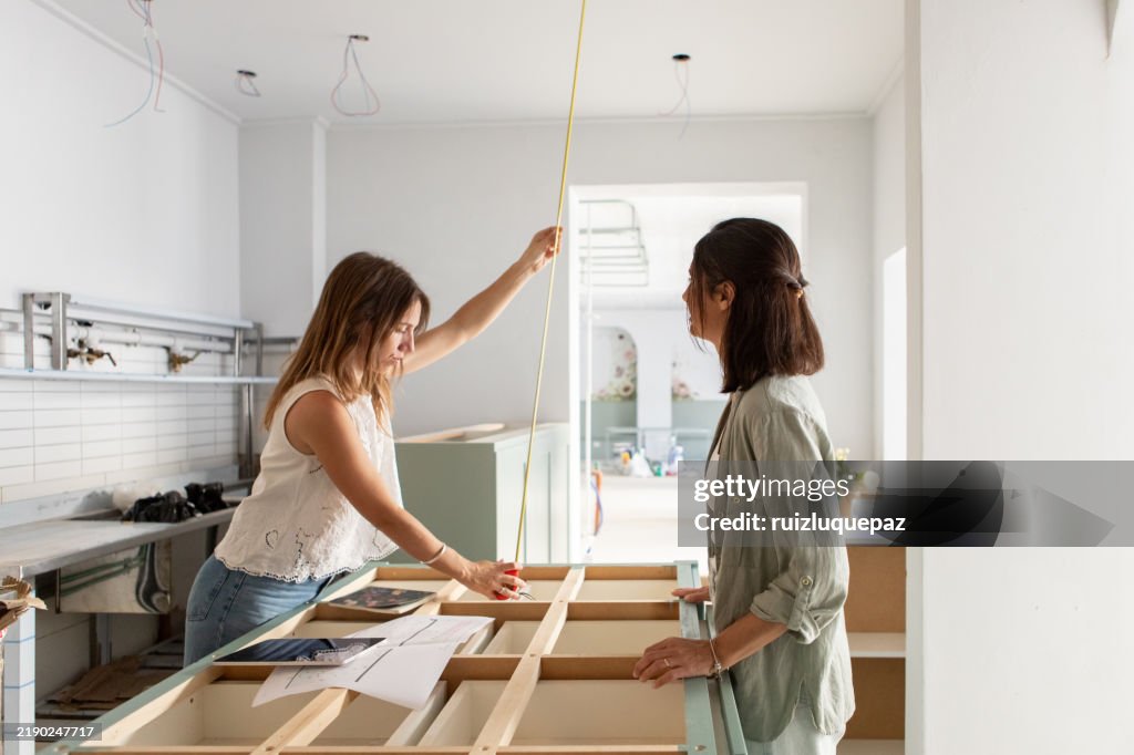 Female architects working on kitchen design