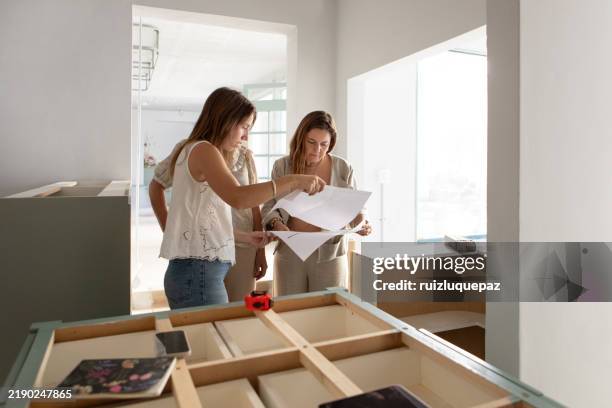 female architects reviewing architectural plans for renovation project - choice stock pictures, royalty-free photos & images