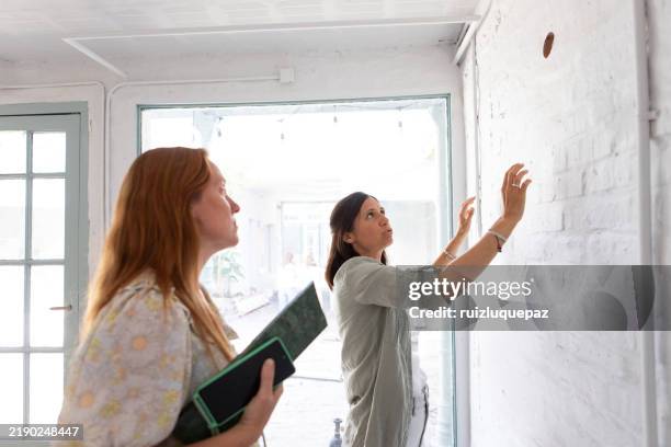 female architects reviewing ideas for renovation project - restaurar imagens e fotografias de stock