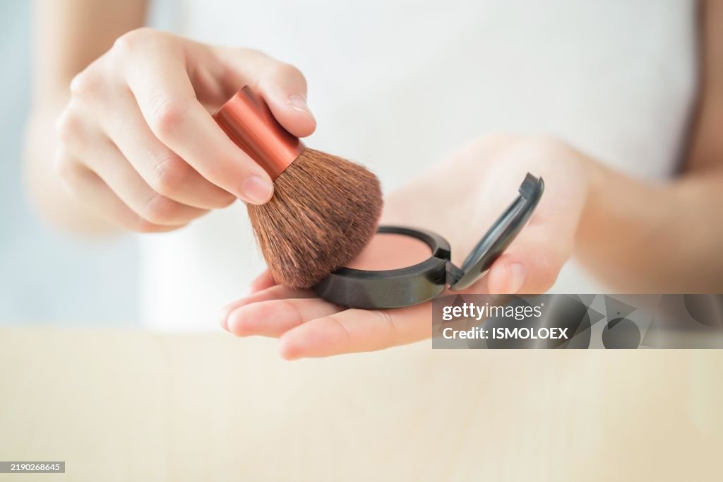 Applying blush with a brush