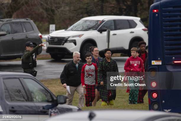 Children are escorted from a church next to the Abundant Life Christian School on December 16, 2024 in Madison, Wisconsin. According to reports, a...
