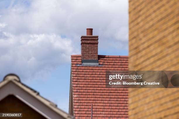 a chimney on the rooftop of a residential building - chimney stock pictures, royalty-free photos & images