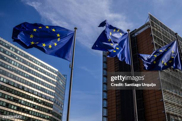 european union flags waiving in front of charlemagne building - europäische kommission stock-fotos und bilder