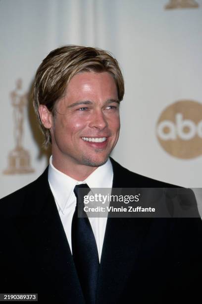 American actor Brad Pitt, wearing a black blazer over a white shirt with a black tie, attends the 72nd Academy Awards, at the Shrine Auditorium in...