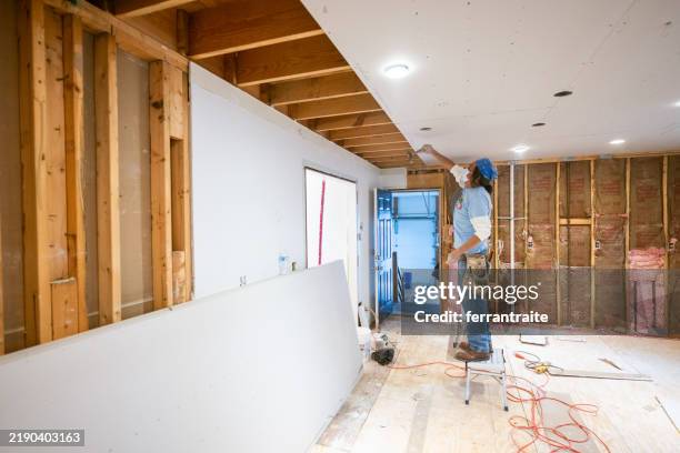 drywall installers working in kitchen renovation - broken drywall stock pictures, royalty-free photos & images