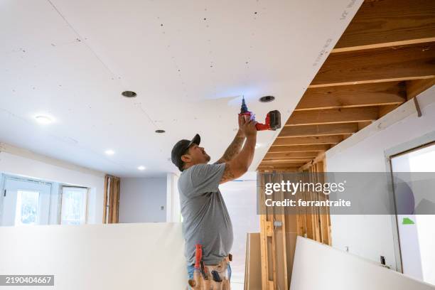 drywall installers working in kitchen renovation - screwdriver stock pictures, royalty-free photos & images