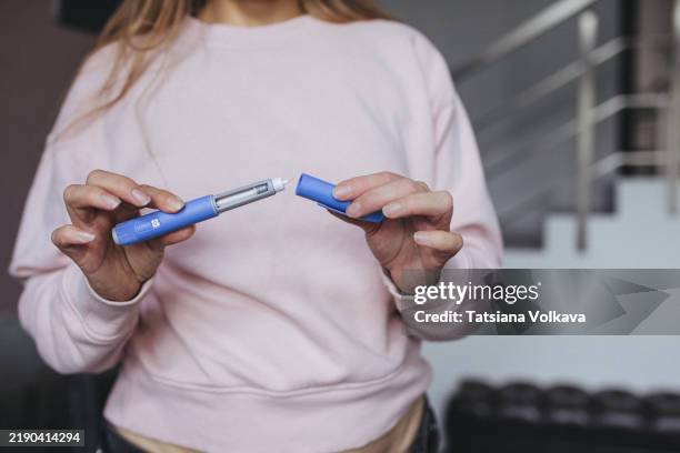 patient preparing opening weight loss injection pen with semaglutide solution - ozempic stock pictures, royalty-free photos & images