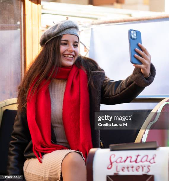 teenager taking selfie at christmas market with santa's mailbox - beret stock pictures, royalty-free photos & images