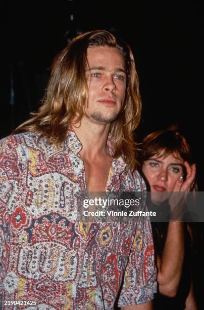 American actor Brad Pitt, wearing a red, white, yellow and blue patterned shirt, with an open collar and rolled-up sleeves, attends the Hollywood...