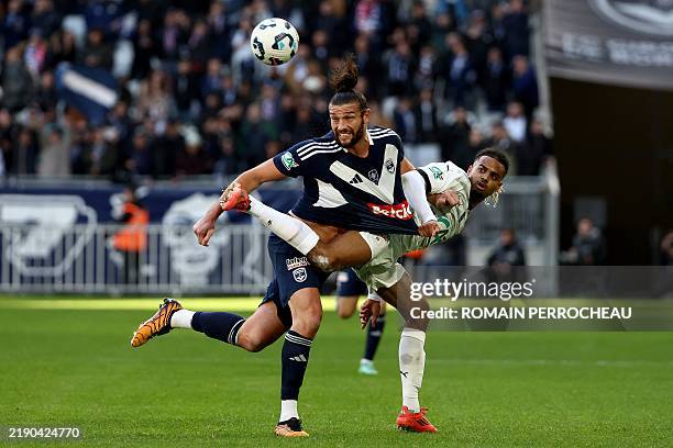 Bordeaux' English forward Andy Carroll and Rennes' French defender Lorenz Assignon fight for the ball during the French Cup round-of-32 football...