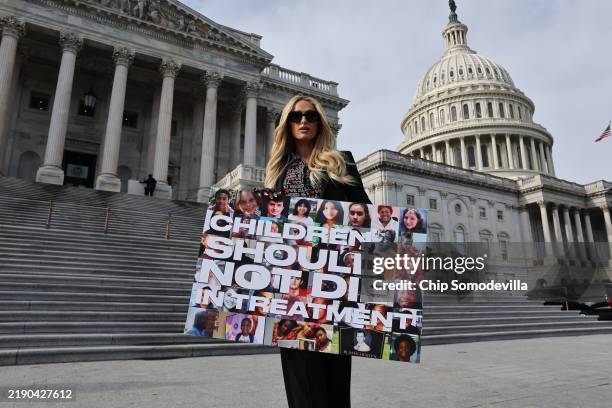 Celebrity hotel heiress Paris Hilton poses for photographs outside the U.S. Capitol on the day the House of Representatives is set to vote on The...