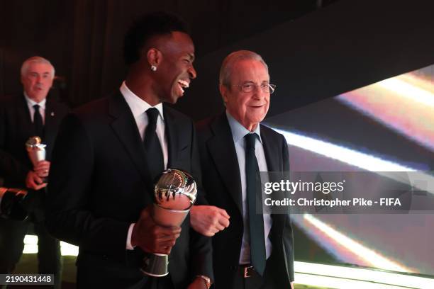 Vinicius Junior of Real Madrid, seen with The Best FIFA Men's Player Award, leaves the venue with Florentino Perez, President of Real Madrid,...