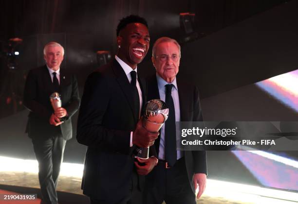 Vinicius Junior of Real Madrid, seen with The Best FIFA Men's Player Award, leaves the venue with Florentino Perez, President of Real Madrid,...