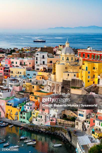 procida island and old harbour at sunset - mediterranean stock pictures, royalty-free photos & images