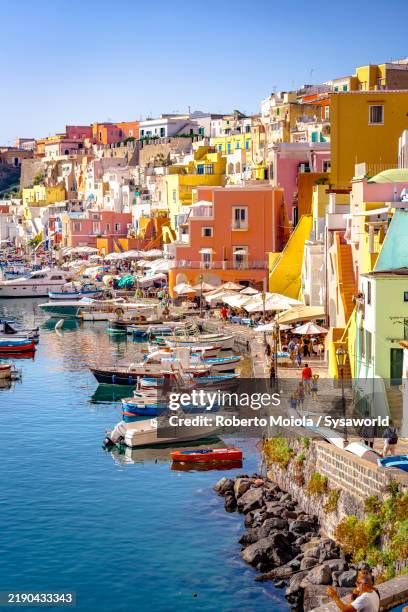tourists walking on waterfront of procida island - southern italy stock pictures, royalty-free photos & images