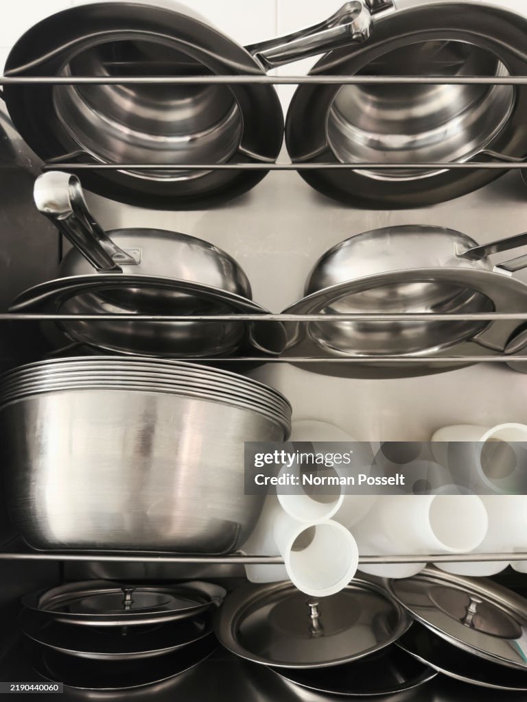 Still life urine bottles and stainless steel bedpans on racks