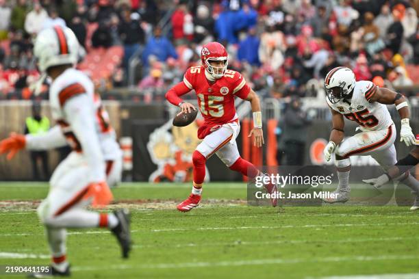Quarterback Patrick Mahomes of the Kansas City Chiefs scrambles away from defensive end Myles Garrett of the Cleveland Browns during the third...