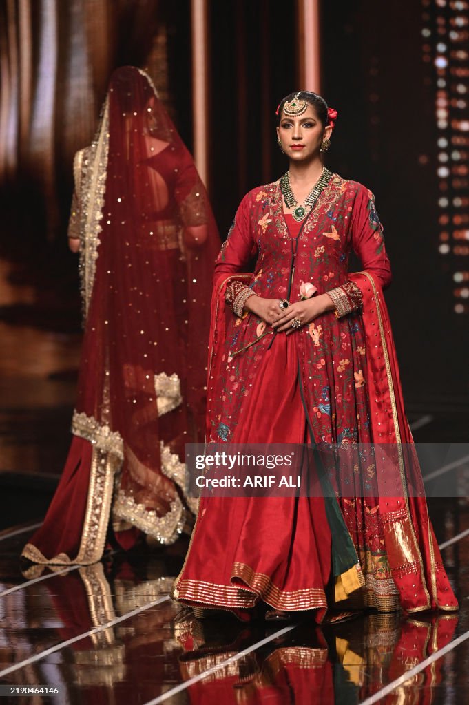 Models present creations by designer Fatima Ashar during the Neo HUM ...