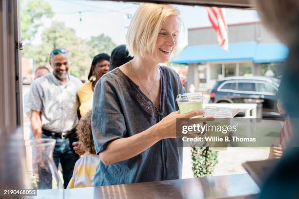 refreshments in hand - small town stock pictures, royalty-free photos & images