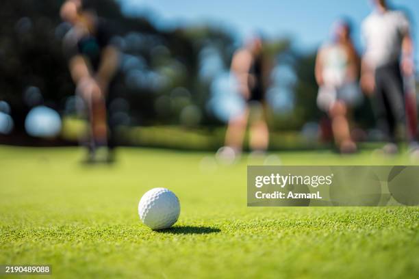 close up on golf ball during a play - campo de golfe imagens e fotografias de stock