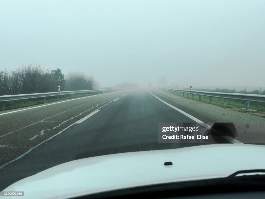 Driving along misty road