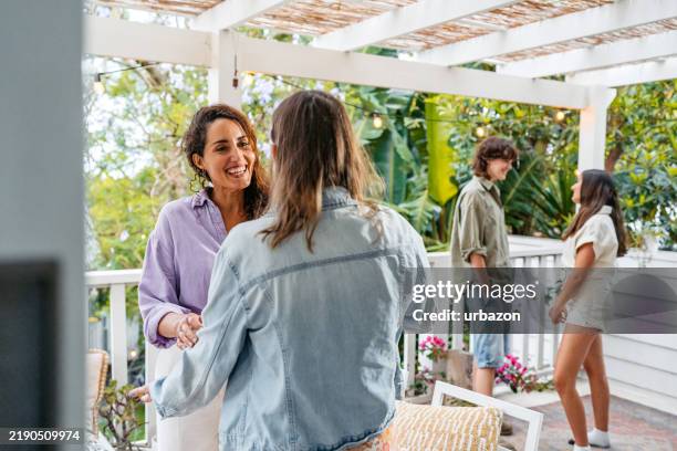 group of people talking on the patio outdoors in sydney in australia - saying hello in different languages stock pictures, royalty-free photos & images