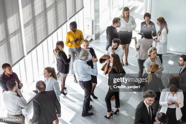 diverse professionals engaging in energetic business discussions - event stockfoto's en -beelden