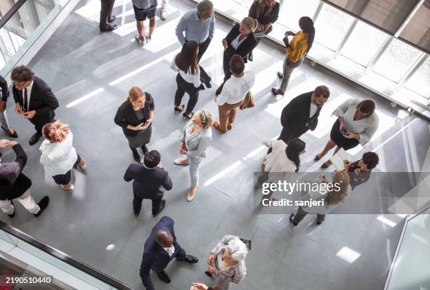 diverse professionals energized engaging at networking event - evento imagens e fotografias de stock