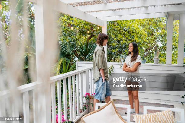 young girl and a transgender boy talking on the patio outdoors in sydney in australia - trans girl stock pictures, royalty-free photos & images