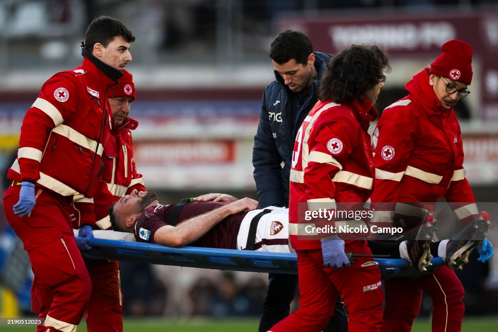 Sebastian Walukiewicz of Torino FC is carried away from the...
