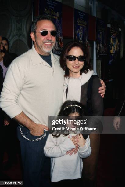 Cuban-American musician and record producer Emilio Estefan, wearing a white shirt with the sleeves rolled up and sunglasses, his wife Cuban-American...