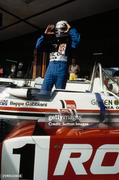 Italian racing driver Beppe Gabbiani prepares to climb aboard the Roloil Onyx Race Engineering March 832 - BMW/Rosche in the pits during practice for...