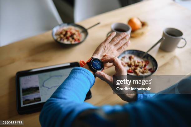 setting up maps on the smartwatch before trail running - smart watch stock pictures, royalty-free photos & images
